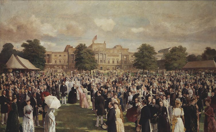 People striding across a lawn in front of a low palace.
